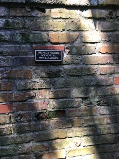 The Chill Garden memorial plaque mounted on a brick wall