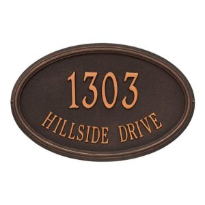 Bronze oval address plaque displaying the text '1303 Hillside Drive' in raised letters.