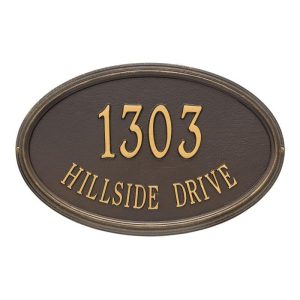 Concord Oval estate wall plaque reading '1303 HILLSIDE DRIVE' in gold lettering on a dark bronze background