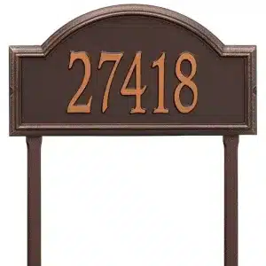 Bronze address plaque displaying the number 27418 in a decorative arch design.