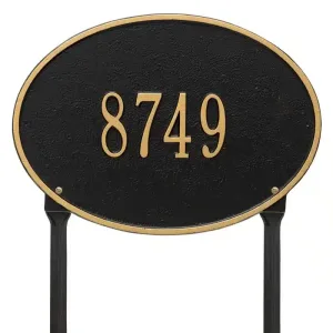 Black oval address plaque featuring the number 8749 in gold lettering on a stand.