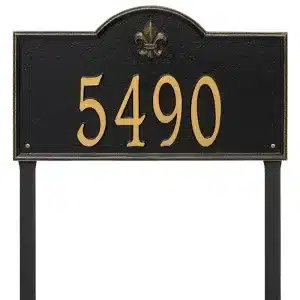 Black address sign displaying the number 5490 with a gold fleur-de-lis emblem at the top.