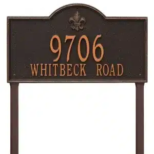 Address sign displaying '9706 Whitbeck Road' with a decorative design and a fleur-de-lis emblem.