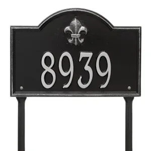 Black address sign displaying the number 8939 with a silver fleur-de-lis emblem at the top.