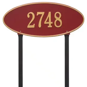 Red oval address sign displaying the number 2748 in gold lettering on a black post.
