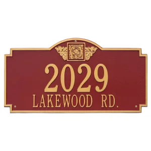 Red Monogram two line wall plaque with gold lettering reading 2029 Lakewood Rd. and a decorative emblem