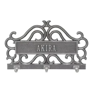 Personalized cast iron key holder featuring the name 'Akira' with decorative scrollwork and three hooks.