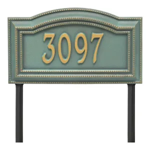 Bronze address plaque displaying the number 3097 in a decorative design with a green background.