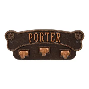 Dog bone-shaped wall hook with the name 'Porter' and four hooks for hanging items.