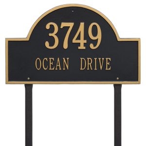 Arch Marker Estate Lawn two line cast aluminum address sign shown installed on stakes in a front yard