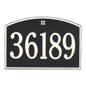 Cape Charles estate wall address plaque with arched top and centered emblem mounted on an exterior wall