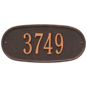 Oval standard wall one line plaque cast from recycled aluminum shown mounted on an exterior wall